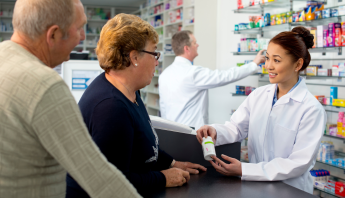 Pharmacist explaining medications to patients.