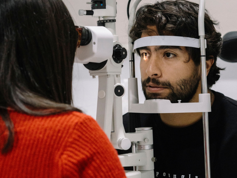 clinician captures retinal images during an eye exam, using advanced imaging to assess optic nerve and retinal health.