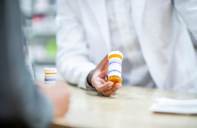 Pharmacist holding prescription.