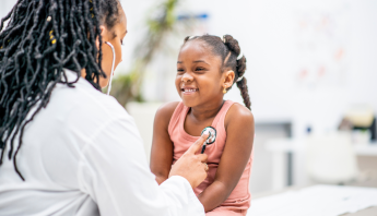 A pediatric patient meets with a clinician during an appointment, receiving supportive care and age‑appropriate guidance.
