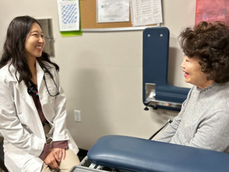 A female doctor meets with a patient during a clinic visit, reviewing concerns and providing supportive, personalized care.