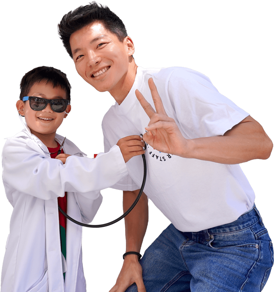 Dr. Kang and child at Kheir Clinic event